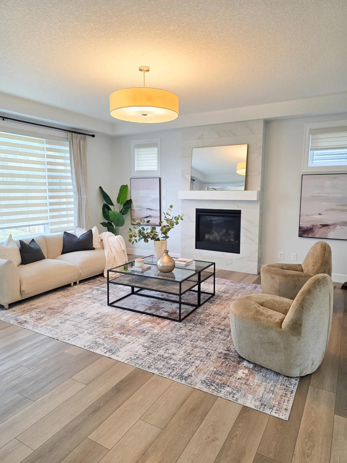 Staged living room with light sofa, accent chair and layered rug