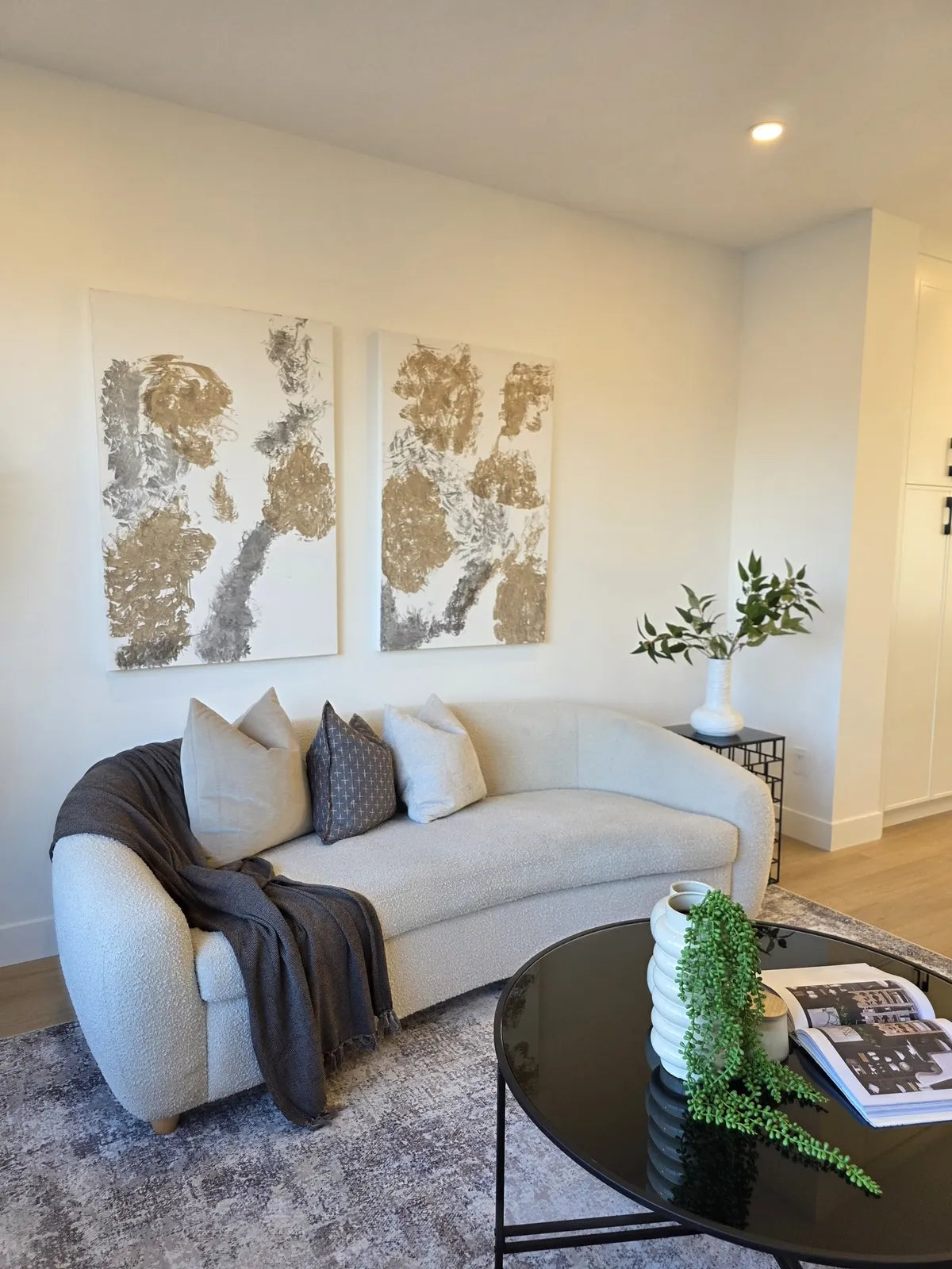 Living room staged with a cream sofa against a dark accent wall