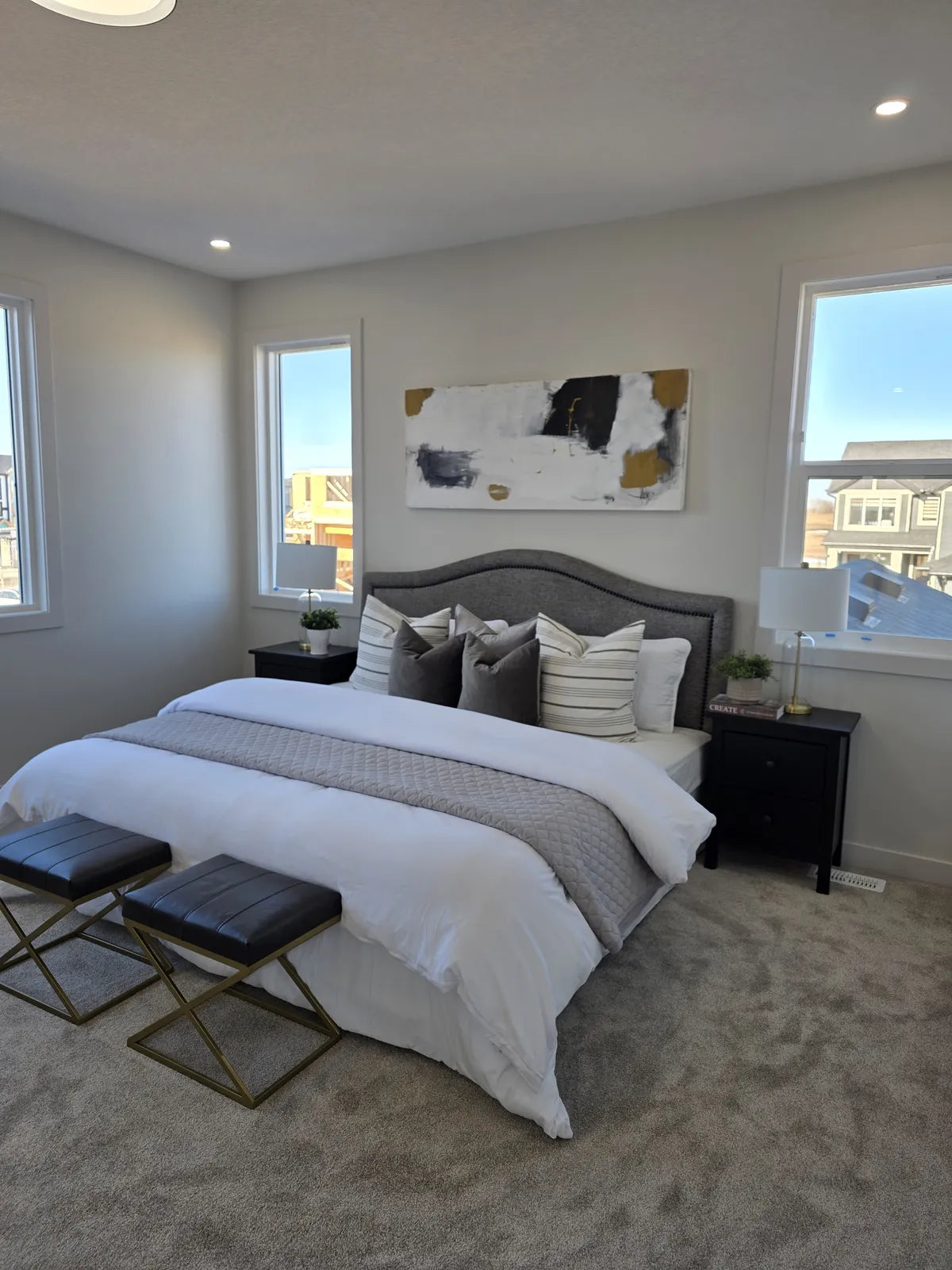 Bedroom styled with a grey tufted headboard and layered bedding