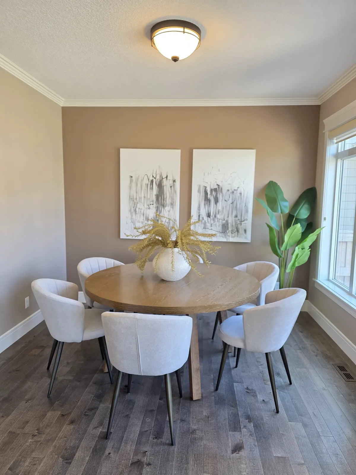 Dining room with a round table beneath a statement chandelier