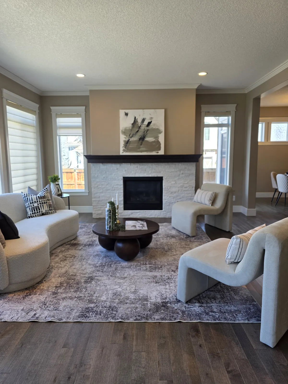 Living room staged around a fireplace with cream seating