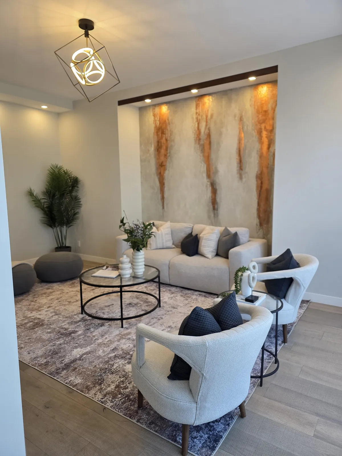 Living room staged with a marble feature wall and cream sofas