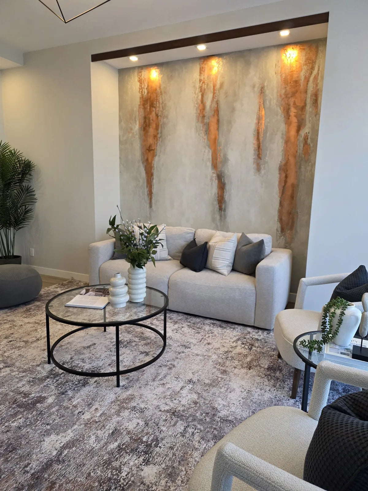Living room staged with a marble feature wall and layered seating