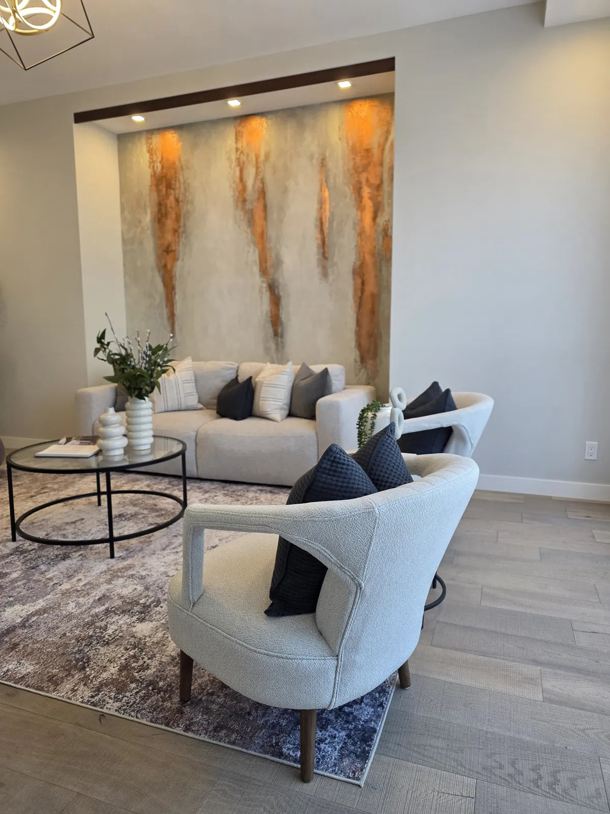 Living room staged with a marble feature wall, alternate angle
