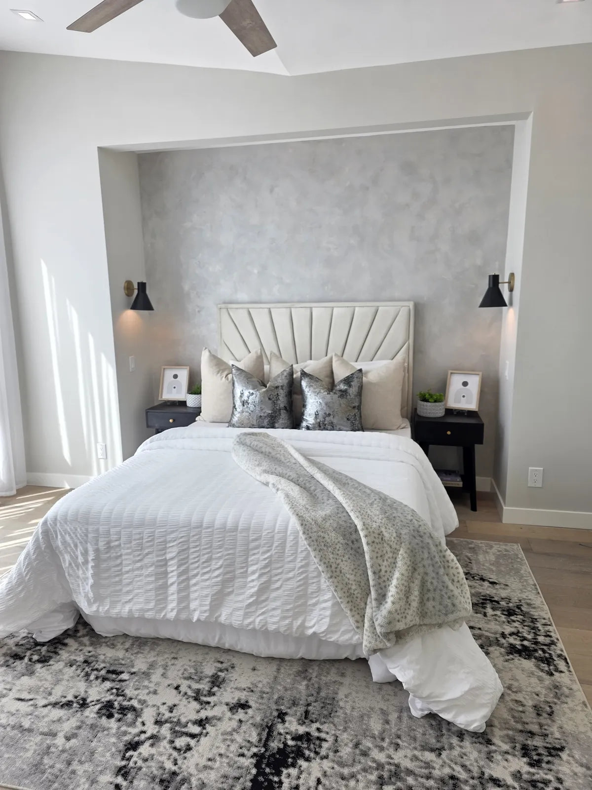 Bedroom styled with a white bed and patterned wallpaper