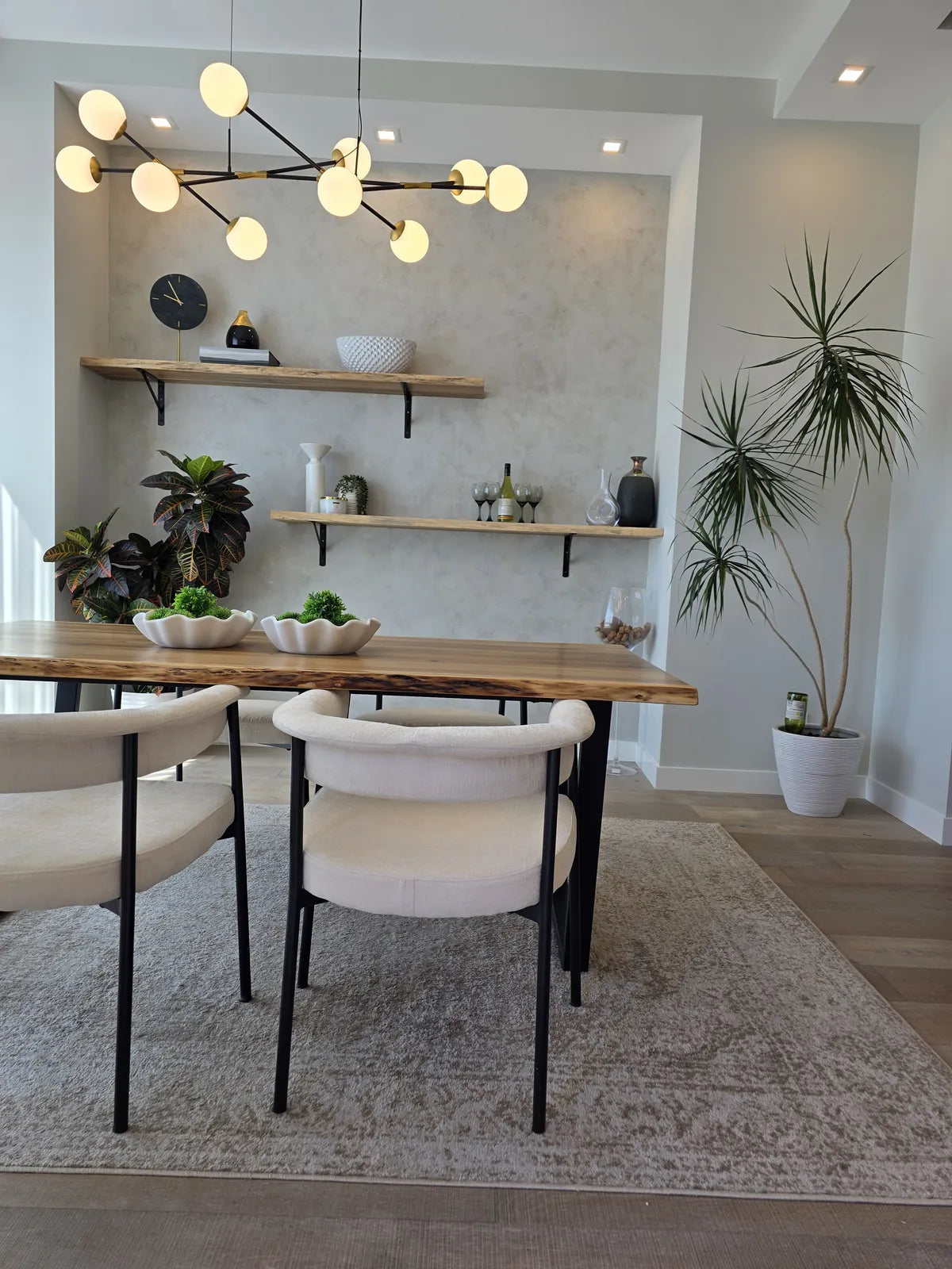 Dining room with a wood table, black chairs and open shelving