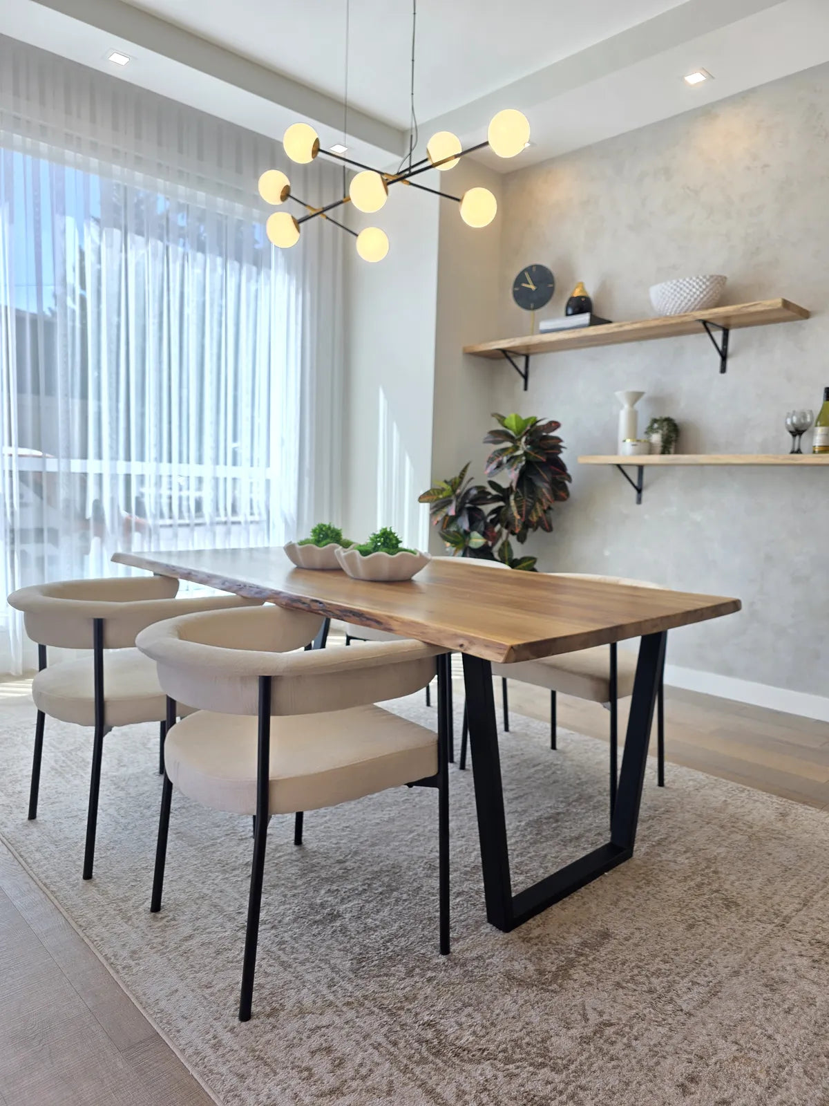 Dining room with a wood table and black chairs, alternate angle