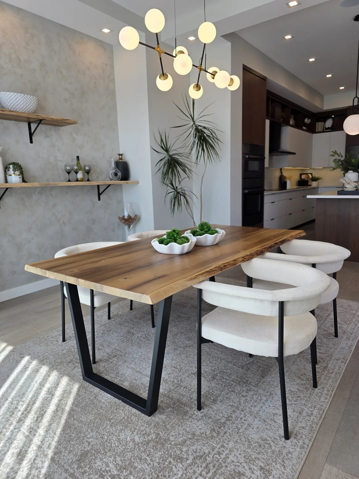 Dining room with a wood table and pendant lighting, alternate angle
