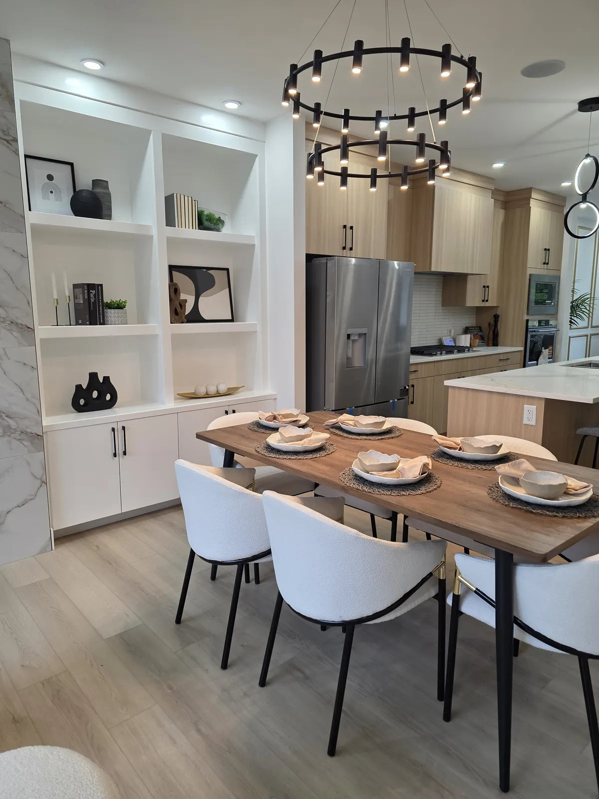 Dining and kitchen area with black counter stools and open shelving