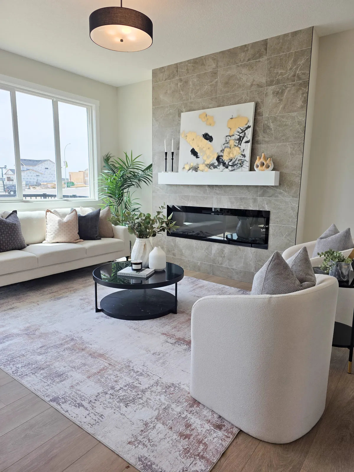 Living room staged around a fireplace with a cream sofa