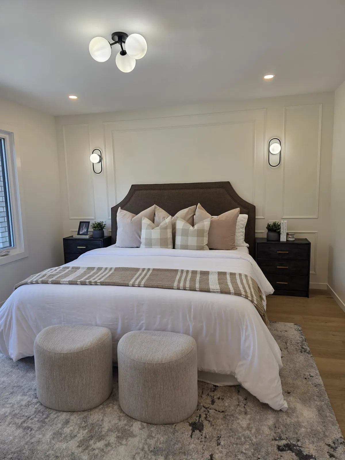 Bedroom styled with a tufted headboard and bench
