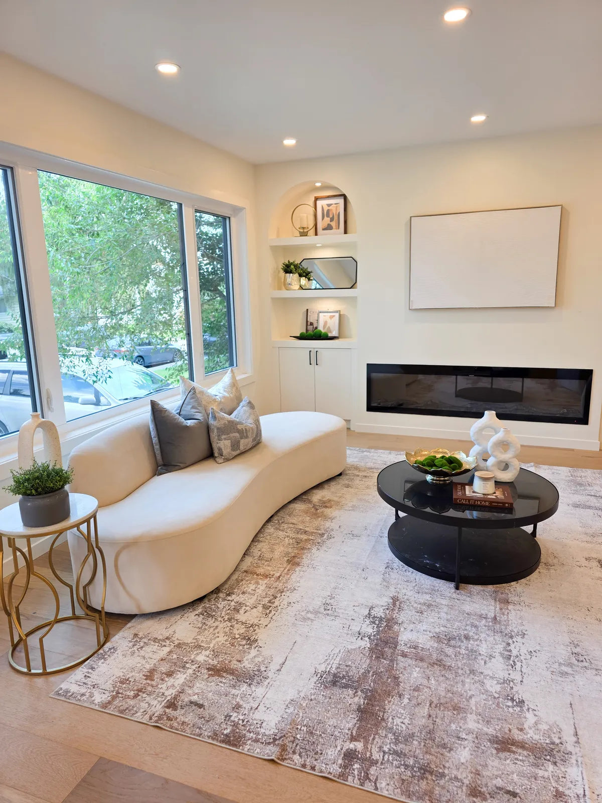 Living room staged with a cream sofa and round coffee table