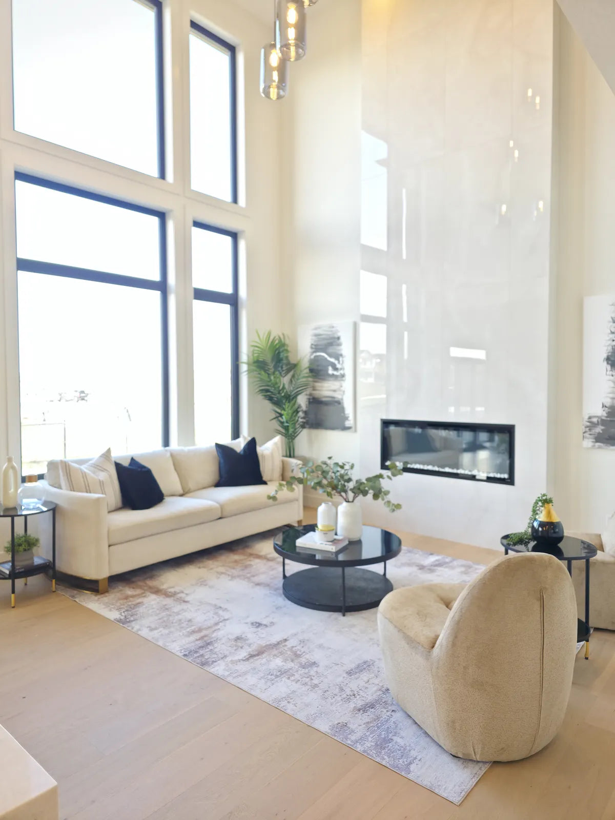 Bright living room with fireplace and floor-to-ceiling windows