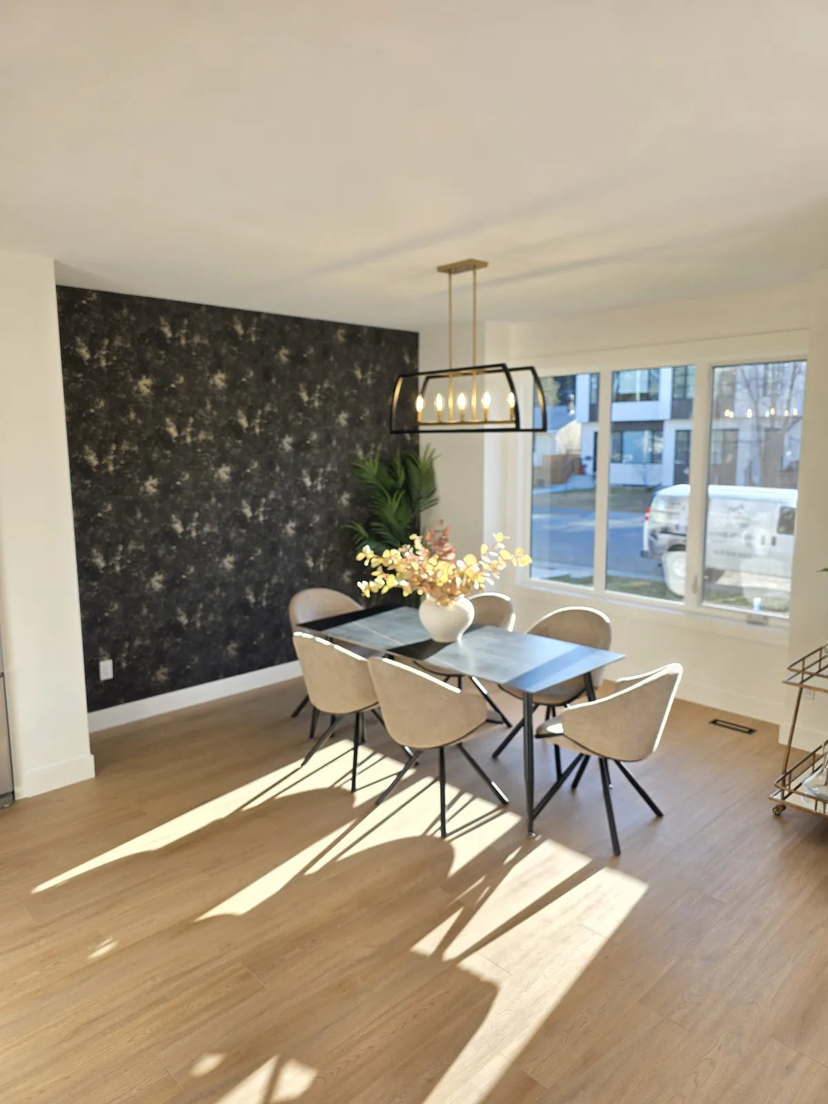 Dining room with a dark table against a black accent wall