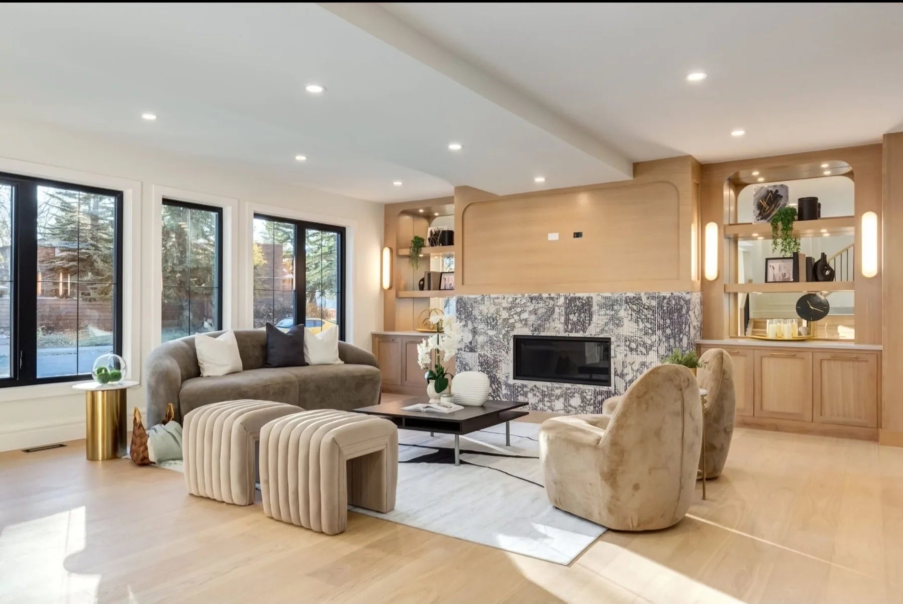 Staged Calgary living room with fireplace and warm layered seating